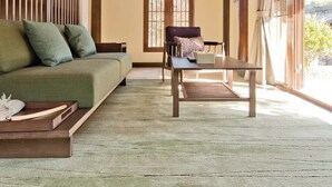 A room with a sofa, a table, and a window with blinds. - ALOR VALLEY HUZHOU (Huzhou)