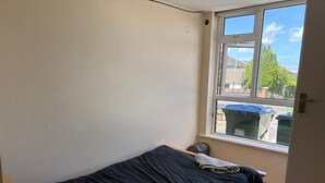 A small, single-bed room with a window overlooking a street and greenery. - Lovely 1-bedroom house in charming Limerick for a relaxing stay (Limerick)