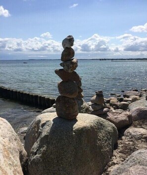 Ein Stapel Steine an einem Gewässer.