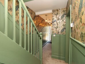 A hallway with green walls and a staircase. - 8 Manor Villas (Totland Bay)