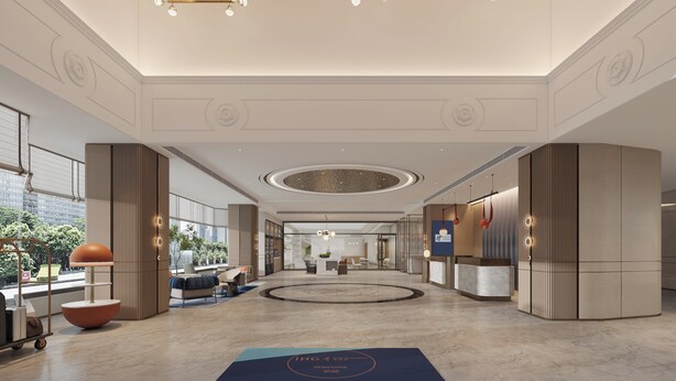 A spacious lobby with a reception desk, seating area, and a large circular feature on the floor. - Holiday Inn Express Jinjiang Dihao Square by IHG (Quanzhou)