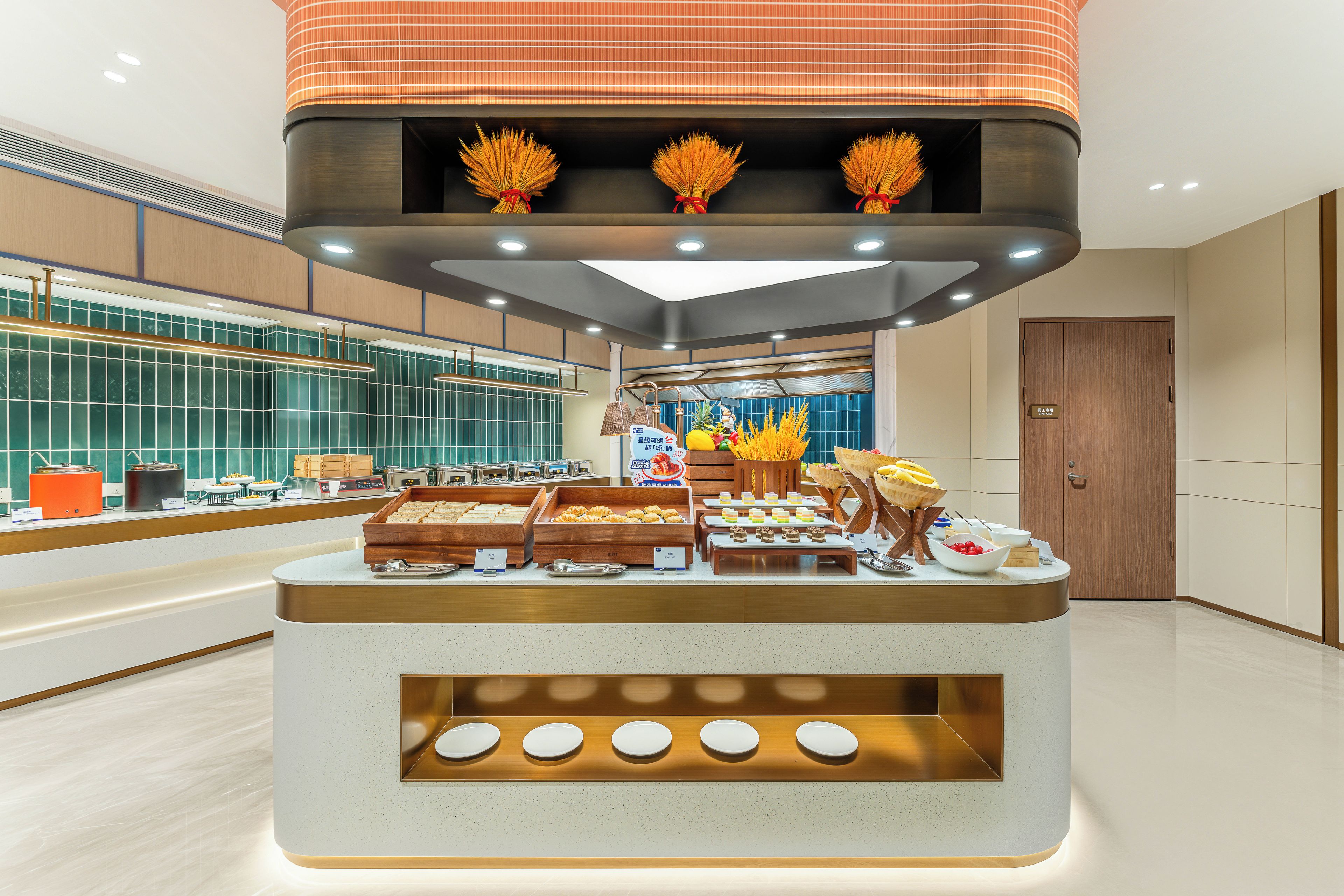 A buffet setup with various food items and a modern interior design.
