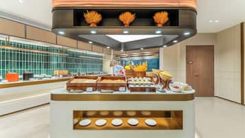A buffet setup with various food items and a modern interior design.