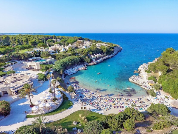 A coastal resort with a beach, swimming area, and a marina. - Hotiday Torre Santo Stefano Resort (Otranto)