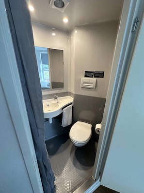 A compact bathroom with a sink, mirror, and toilet. - Central Liverpool En-suites – Cosy & Affordable (Liverpool)