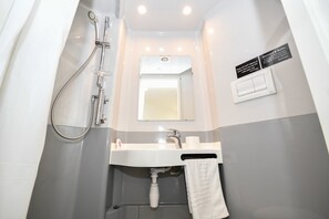 A small, modern bathroom with a shower, sink, and mirror. - Budget En-suites, Central Liverpool (Liverpool)