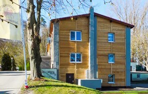 A two-story building with a wooden facade, multiple windows, and a red roof. - Pet friendly apartment in Barth with WiFi (Barth)
