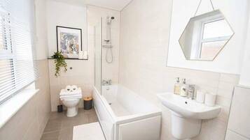 Shower, hair dryer, towels, shampoo