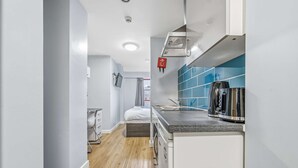 A compact kitchen with a coffee maker, a microwave, and a small sink. - Budget Double Studio Room in Central Nottingham (Nottingham)