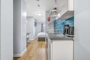 A compact kitchen with a coffee maker, a microwave, and a small sink. - Budget Double Studio Room in Central Nottingham (Nottingham)
