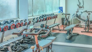 A gym with exercise equipment, including dumbbells, a treadmill, and a stationary bike. - Modern Budget Single Studio in Central Nottingham (Nottingham)