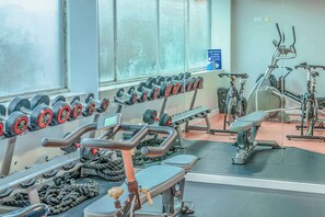 A gym with exercise equipment, including dumbbells, a treadmill, and a stationary bike. - Modern Budget Single Studio in Central Nottingham (Nottingham)