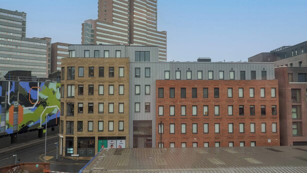 A multi-story building with a flat roof, large windows, and a brick facade. - Cosy Budget Single Studio in Central Nottingham (Nottingham)