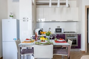 A modern kitchen with white cabinets, a refrigerator, a microwave, and a stove. - A comfortable and practical 40 square meters studio apartment, perfect for three people, located on the first floor of a building with an elevator (NOT accessible to disabled guests).The property is located near Pisa Centrale Train Station, making it the (Pisa)