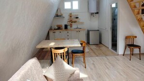 A compact kitchen with a dining area, wooden ceiling, and a staircase. - Metsadzor Resort, Areni (Areni)