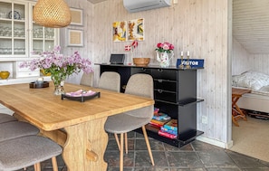 A dining area with a wooden table, grey chairs, a black bookshelf, and a 'VISITOR' sign. - Stunning home in Sjølund with sauna (Sjølund)