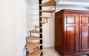 A corner with a wooden spiral shelf unit and a wooden cabinet. - Amazing home in Vers-Pont-Du-Gard with WiFi (Vers-Pont-Du-Gard)
