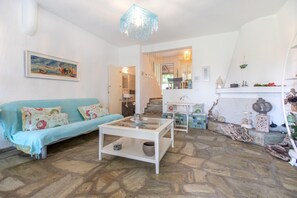 A living room with a sofa, coffee table, and decorative items.