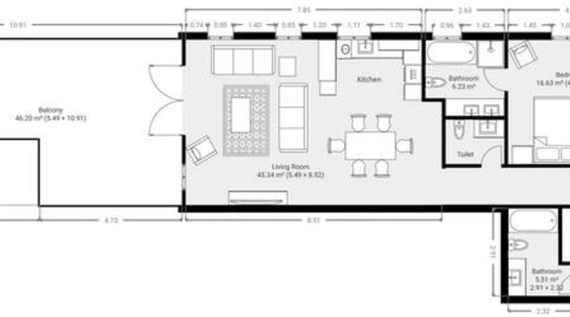 A floor plan with a balcony, living room, kitchen, two bathrooms, and a bedroom.