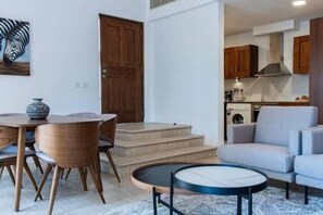 Ein modernes Interieur mit Essbereich, einer Couch und einer Küche.