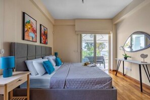A bedroom with a bed, a bedside table, a mirror, and a window.