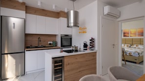 A modern kitchen with a built-in oven, a coffee maker, and a wine rack. - Villa Kimm by Villas Guide (Labin)