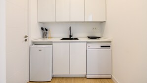 A compact kitchen with white cabinets, a sink, a dishwasher, and a compact refrigerator. - (SDB1L2) 1 bedroom apartment in Tetuán, Madrid (Madrid)