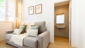 A neutral-toned living room with a sofa, pillows, a lamp, and a framed picture on the wall. - (SDB1L2) 1 bedroom apartment in Tetuán, Madrid (Madrid)