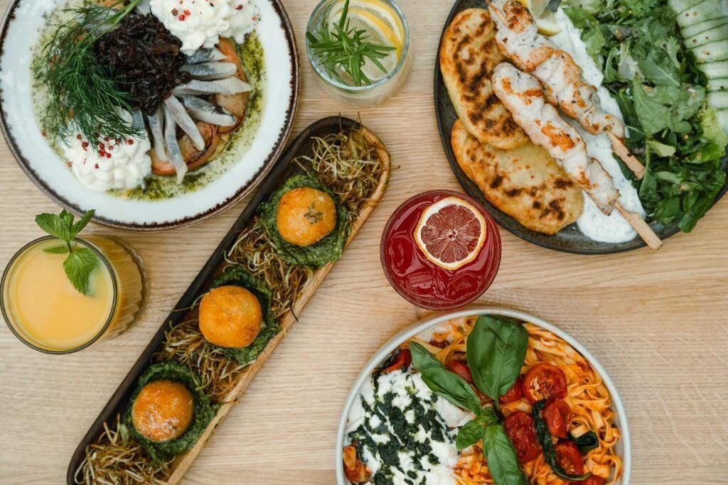 A variety of dishes including seafood, grilled chicken, and pasta, suggesting a diverse meal selection.