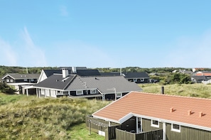 Een woonwijk met huizen met schuine daken en een gazon op de voorgrond.