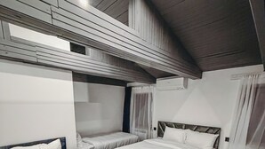 A room with two beds, a wooden ceiling, and a carpeted floor. - Pushkin Hotel Yerevan (Yerevan)