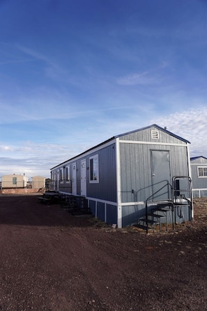 A single-story mobile home with a front porch and a small attached garage. - Quiet Escape Studio Perfect for Exploring Natural Wonders in Williams, Arizona (Williams)