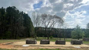 A park with covered tables and benches, surrounded by trees and open grassy areas. - Unique Earth Home Stay with Pet Goats and Fishing Pond near Lake Gaston NC (Littleton)