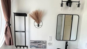 A modern bathroom with a toilet, bidet, vanity with a sink, and a mirror.