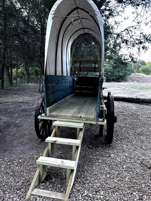 A covered wooden carriage with a ramp leading up to the entrance.