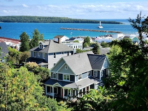 A coastal residential area with houses, a lighthouse, and a pier.