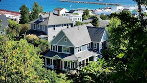 A coastal residential area with houses, a lighthouse, and a pier.
