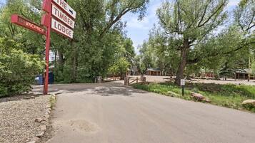 A lodge entrance with a sign indicating no vacancy and directions to the timber lodge.