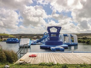 A water park with inflatable slides and a wooden dock. - 57 Cliff End (Freshwater)