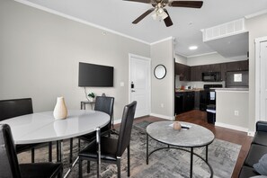 A modern kitchen with dark cabinets, a microwave, and a refrigerator. - Modern 1br living in New Braunfels (New Braunfels)