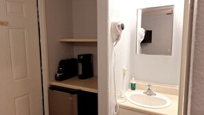 A bathroom with a white sink, a mirror, a hairdryer, and a shelf with a coffee maker. - Charming Private Studio for Relaxing Nature Escapes in Williams, Arizona (Williams)