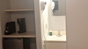 A bathroom with a sink, a mirror, a hairdryer, and a small cabinet. - Charming Private Studio for Relaxing Nature Escapes in Williams, Arizona (Williams)