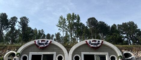 Two arched structures with circular windows and a flag on top.