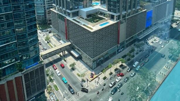 A high-rise building with multiple floors, a rooftop garden, and a swimming pool. - New! Serene & Cozy,  1 bedroom, Wi-Fi 350Mbps  Uptown BGC, Step from Mall BH6 (Taguig)