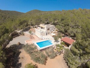 A two-story house with a swimming pool, surrounded by trees and hills. - Can Damià _ San Josep _ Ibiza (Sant Josep de sa Talaia)