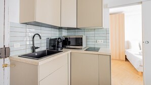 A compact kitchen with a sink, coffee maker, and microwave. - 2 People #1 Bedroom #Invalides #Eiffel Tower #Paris 07 (Paris)