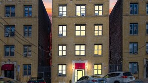 A multi-story building with a red awning, several windows, and parked cars in front. - FIFA World Cup Stay • Easy Transit to MetLife • Near NYC (Jersey City)