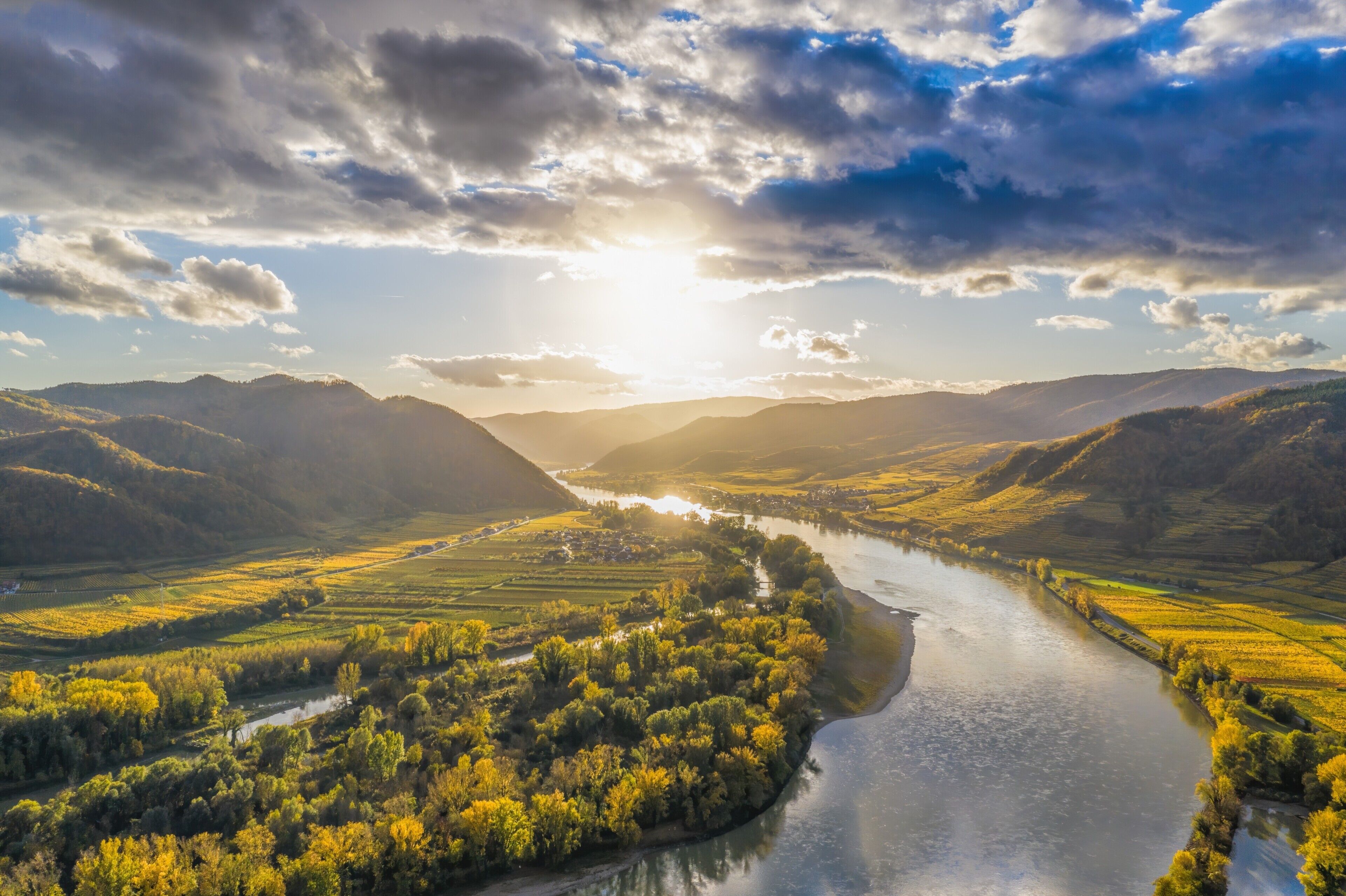 A river winding through a valley with hills on either side.