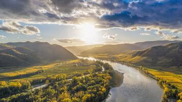 A river winding through a valley with hills on either side.