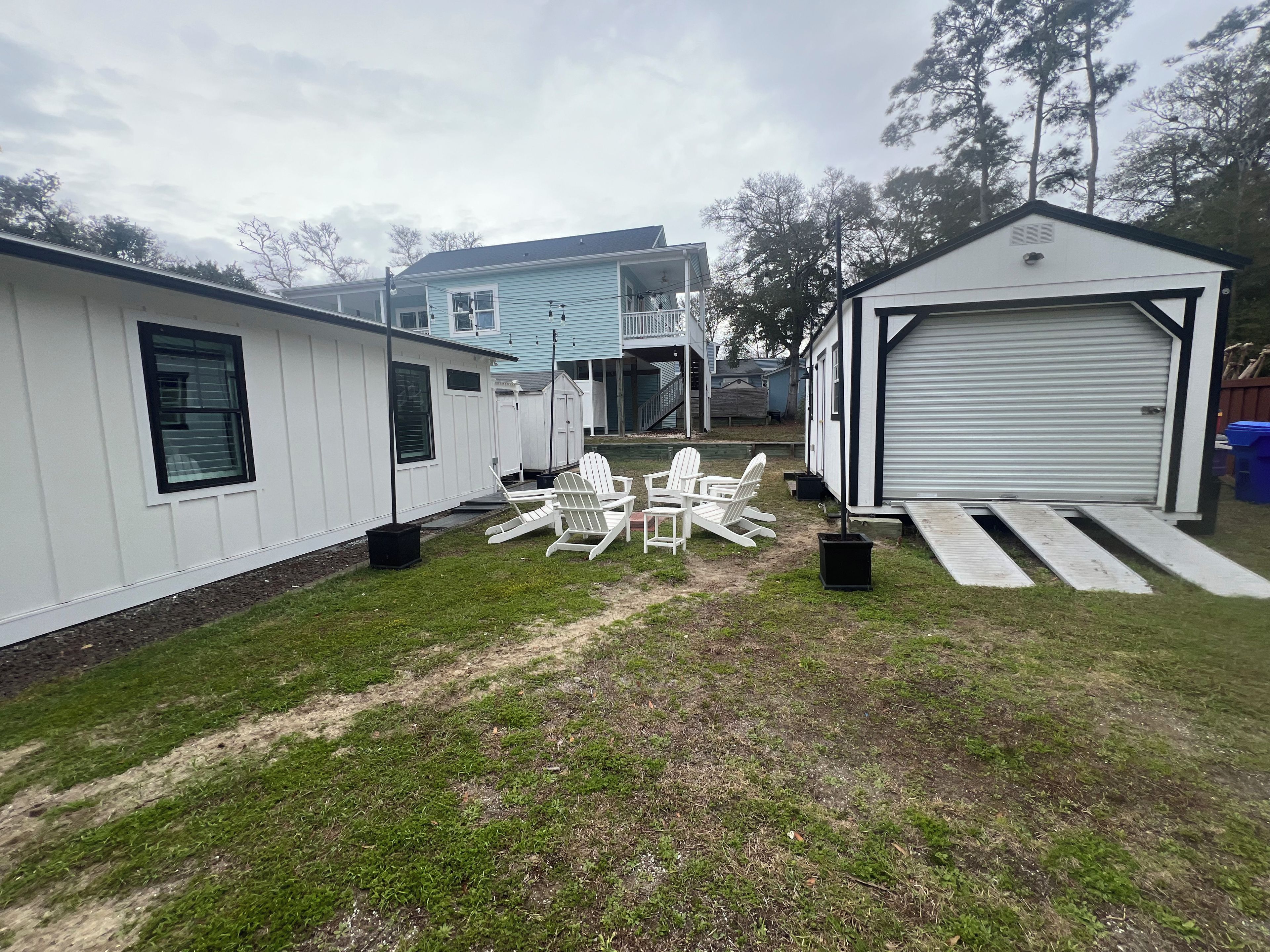 A residential area with mobile homes, a covered patio, and outdoor seating.